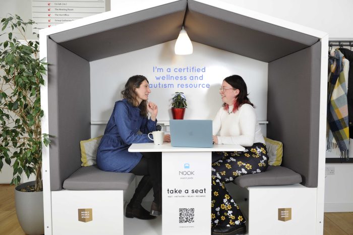 2 women chat in a Nook of The Melting Pot