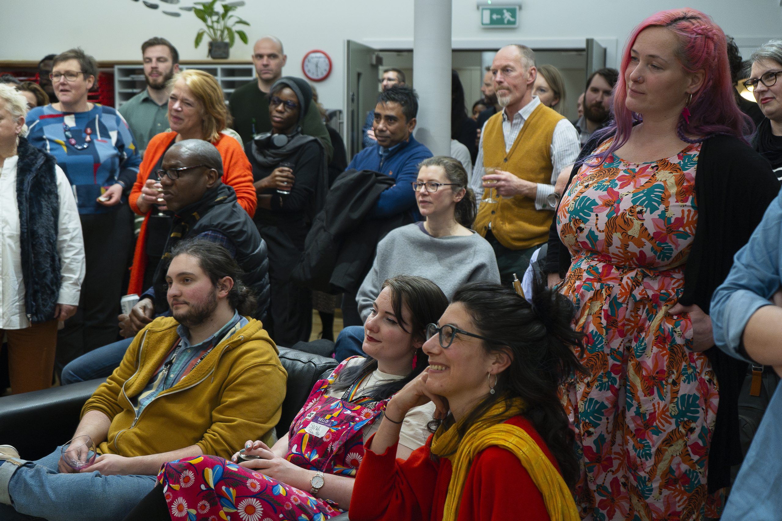 A crowd of people in The Melting Pot listening to a speaker at an event